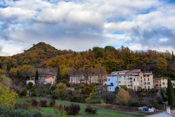 Fototapeta na wymiar Homes in a small touristic town, Montferrat, France. Cloudy Fall Season Sky.