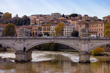 Fototapeta na wymiar River Tiber and Bridge in a historic City, Rome, Italy. Sunny and Cloudy day.