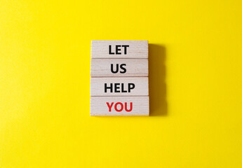 Let us help you symbol. Wooden blocks with words Let us help you. Beautiful yellow background. Business and Let us help you concept. Copy space.