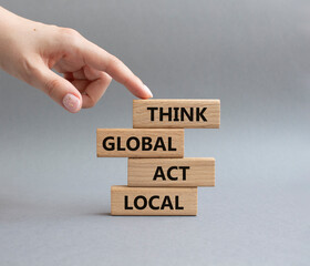Think global act local symbol. Wooden blocks with words Think global act local . Beautiful grey...