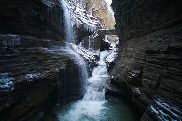 Fototapeta na wymiar a cascade of waterfalls inside a cavern. rainbow falls at watkins glen state park in new york 