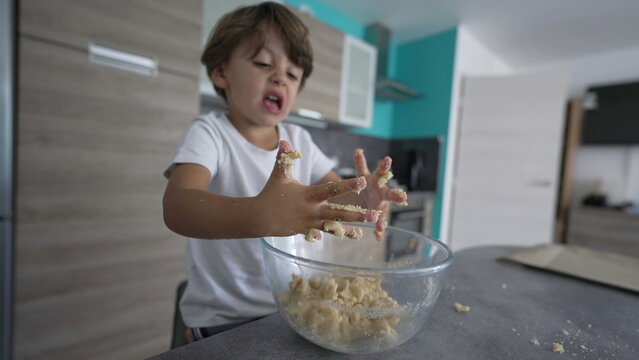 Cute Child With Messy Hands While Preparing Dough. Kid Cooking Food Dirty Hand