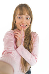 Fototapeta premium Smiling woman with raised eyebrows taking selfie on a white background. High quality photo