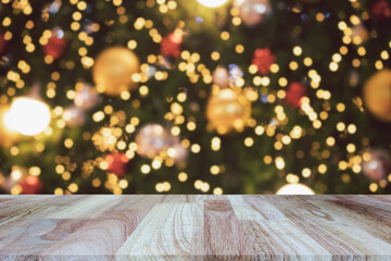Wooden table top (counter bar) with Blurred background of Christmas Tree with Decoration christmas lights. Banner for advertise on online media. For montage product display visual layout.