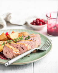 Fototapeta na wymiar Duck breast with potatoes and berry sauce on white background, selective focus