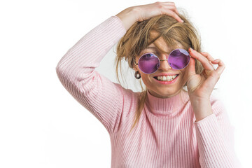 Happy smiling woman in sunglasses messing her blond hair up on a white background. High quality...