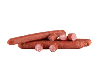 Whole half-smoked sausages and cut pieces of sausage on a white background.
