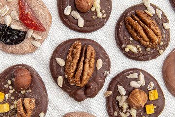 French sweets with walnuts and berries. Chocolate mediants. Home pastry chef. Closeup