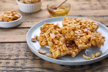 Delicious peanut kozinaki bars on wooden table