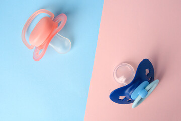 Baby pacifiers on color background, flat lay