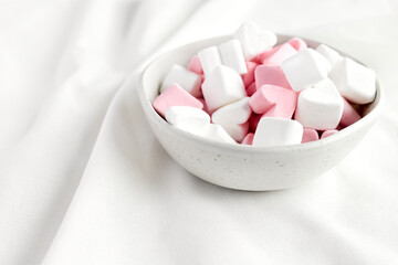 Pink and white marshmallows heart shape. Fluffy sweets for love theme or Valentine concept in pastel tone.