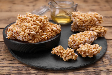 Puffed rice pieces (kozinaki) on wooden table, closeup