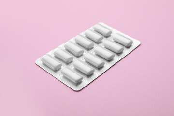 Blister with chewing gums on pink background