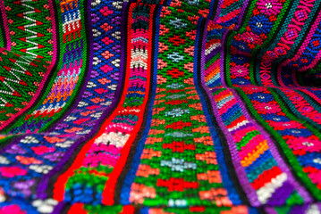 Handmade textile detail made by Guatemalan artisan in Central America, colorful detail full of...