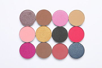 Beautiful eye shadow refill pans on white background, flat lay