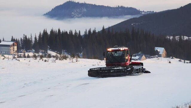 12.01.23 Dragobrat, Ukraine Ratrak rides through the snowy mountains and clears track for snowboarders. Snowy winter is high in Ukraine. Dragobrat covered in snow