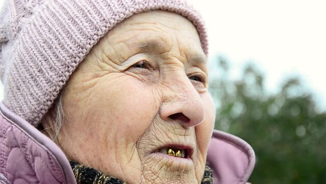 Old grandmother. The face of an old grandmother. Old face close up. Elderly woman. Ukrainian woman. War in Ukraine. Grandma smiles. Wrinkles on the face of an old grandmother. Wrinkled face close up