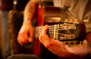 Musician is playing the acoustic guitar at night concert at a cottage in Canada