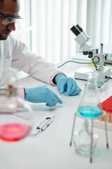 Fototapeta premium Laboratory worker checking blood of patient for diseases and viruses