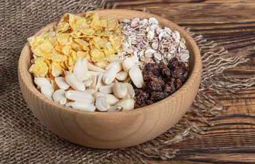 Breakfast of muesli, nuts, raisins, fresh berries and cereal.