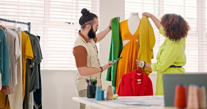 Fashion, ecommerce or tablet and a designer team working together with sample fabric on a mannequin. Startup, creative and teamwork with a man and woman at work on design in their studio workshop