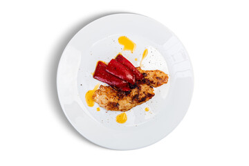 Chicken breast with peppers and spicy oil on white background.