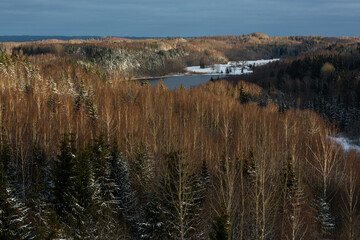 sunny snowy winter day in the countryside with lake
