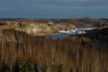 sunny snowy winter day in the countryside with lake