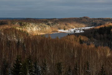 sunny snowy winter day in the countryside with lake