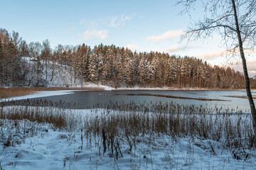 sunny snowy winter day in the countryside with lake