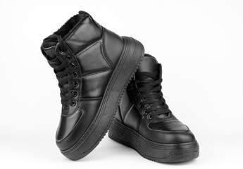 Black shoes on a white background. Stylish winter shoes. Big black boots