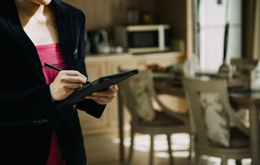 Mature businessman using a digital tablet to discuss information with a younger colleague in a modern business lounge