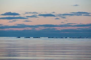 Wonderfully beautiful sunset by the sea in winter with ice