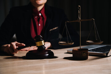 Justice and law concept.Male judge in a courtroom with the gavel, working with, computer and...