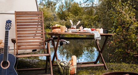 Picnic in nature.Wooden chair,table.Barbecue BBQ B-B-Q food. Family holiday travel,vacation weekend...