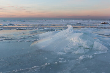 Wonderfully beautiful sunset by the sea in winter with ice
