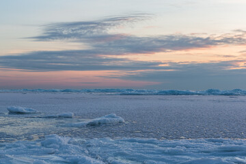 Wonderfully beautiful sunset by the sea in winter with ice
