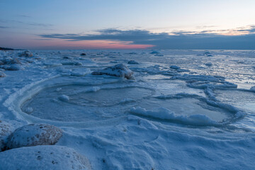 Wonderfully beautiful sunset by the sea in winter with ice