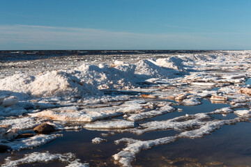 Wonderfully beautiful sunset by the sea in winter with ice