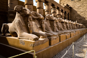 Ram-headed sphinx statues at the entrance of the Karnak Temple in Luxor, Egypt.
