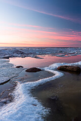 Wonderfully beautiful sunset by the sea in winter with ice