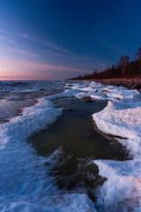 Wonderfully beautiful sunset by the sea in winter with ice