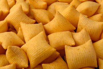 Salty bacon chips background or texture.