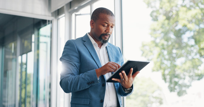Business man, tablet and thinking in office lobby while browsing internet, social media or researching. Technology, idea and black man with digital touchscreen for web scrolling, networking or email. - Powered by Adobe
