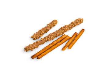 Cracker pretzel sticks toffee-cream glazing and peanuts isolated on white background.