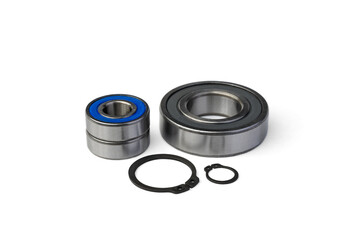 Ball bearings and circlips (retaining rings) for shafts isolated on white background.