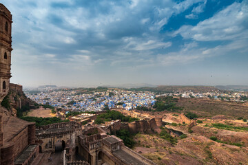 Obraz premium Top view of Jodhpur city as seen from famous Mehrangarh fort, Jodhpur, Rajasthan, India. Blue sky in the background. Mehrangarh Fort is UNESCO world heritage site popular amongst tourists worldwide.