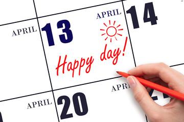 Hand writing the text HAPPY DAY and drawing the sun on the calendar date April 13