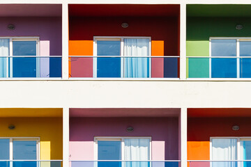 Close-up of a multi-colored apartment building with glass balconies