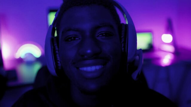 African teenager gamer playing pc video games inside videogame room - Technology trend